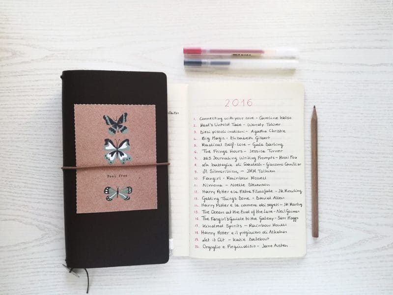 A book journal opened to a page that says 2016 and includes a list of books read as a reading log