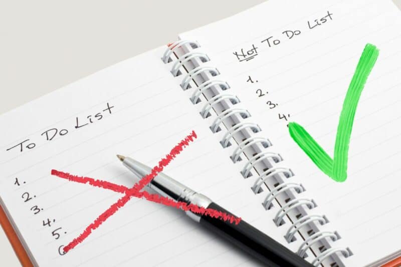 Image of a notebook with a to do list on the left page and a not to do list on the right page. The to do list has a red X superimposed over it and the not to do list has a green check mark superimposed over it