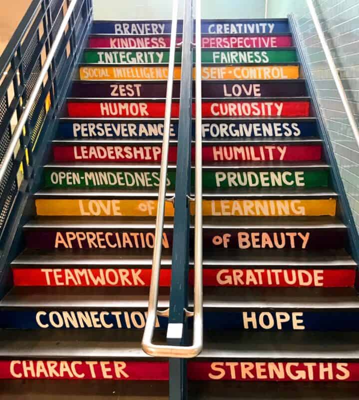 Inspirational words painted on a staircase. Positive affirmations are one of many positive thinking exercises you can do in your journal
