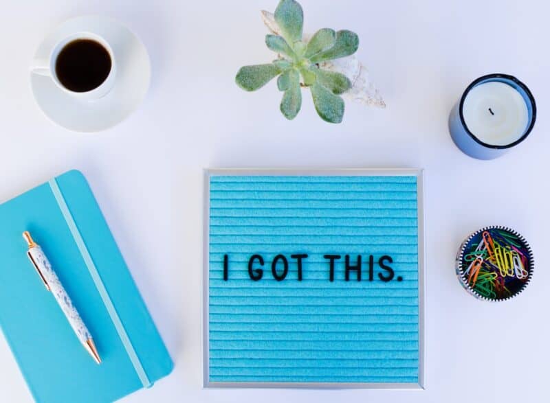 Motivational words spelling out "I Got This" on a blue letterboard with journal next to it