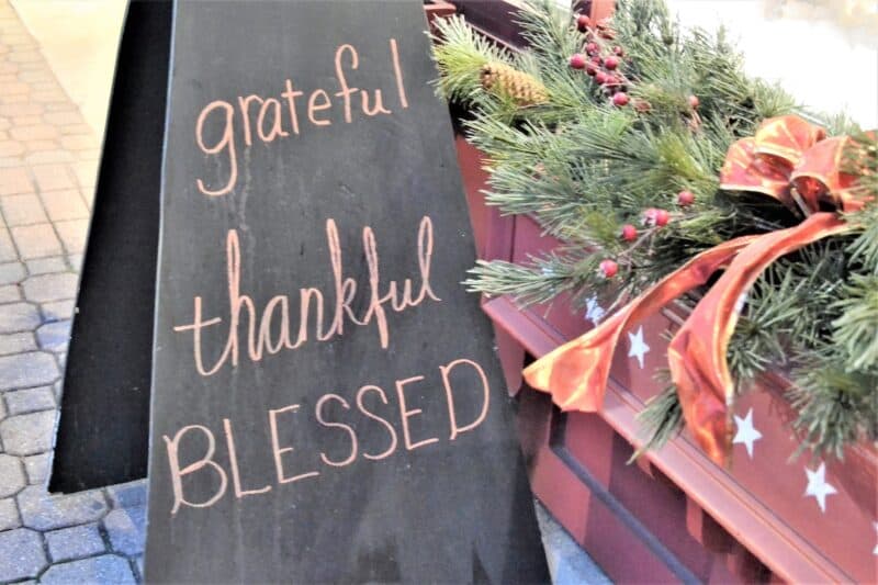 Chalkboard sign that says "Grateful Thankful Blessed" for a post about the difference between grateful vs thankful
